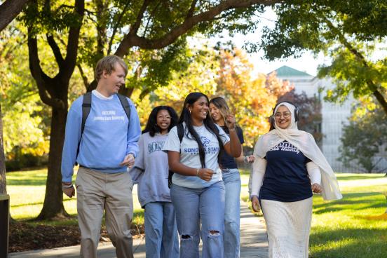 Group walking and socializing on campus