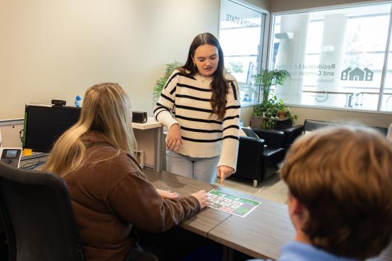 Student pointing to housing map in the REACH office