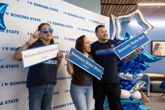 Family members holding SSU signs at reception