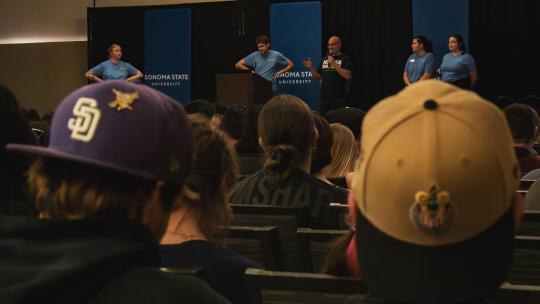 Students listening at REACH orientation 