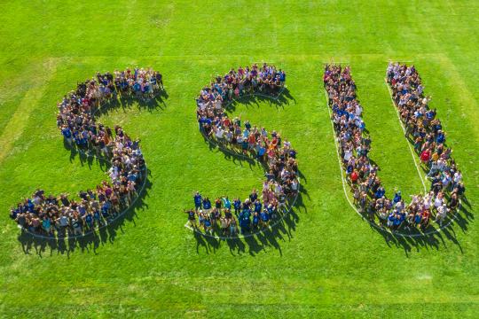 Aerial view of group forming the letters 'SSU'