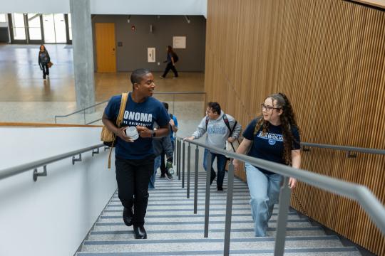 A group of students walk up Stevenson's staircase