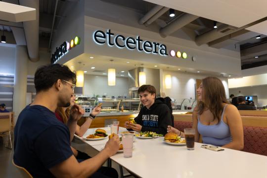 Students talk and share a meal together
