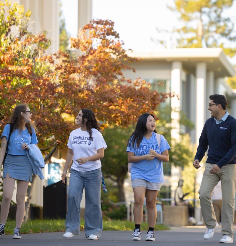 Students walking on campus during the fall