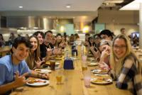 Students eating a meal together.