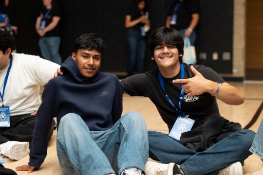 two boys sitting on ground